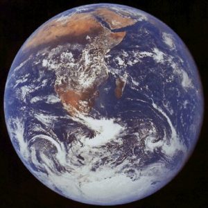 Blue, cloud-covered disk of Earth with Africa showing.