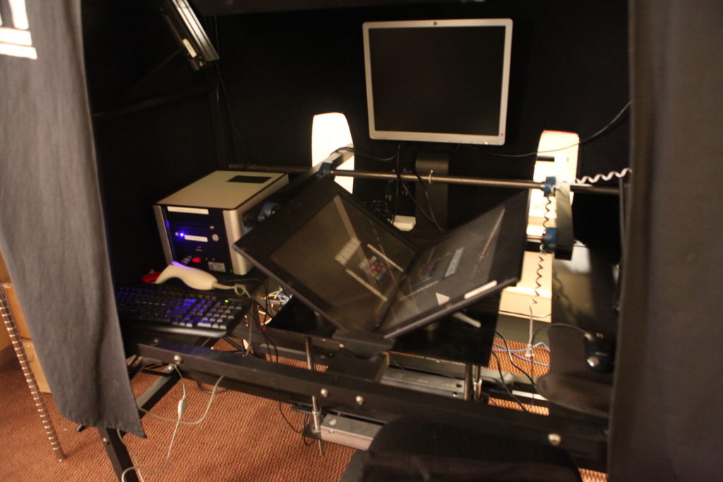 Desk with glass and metal scanner set up in V shape.